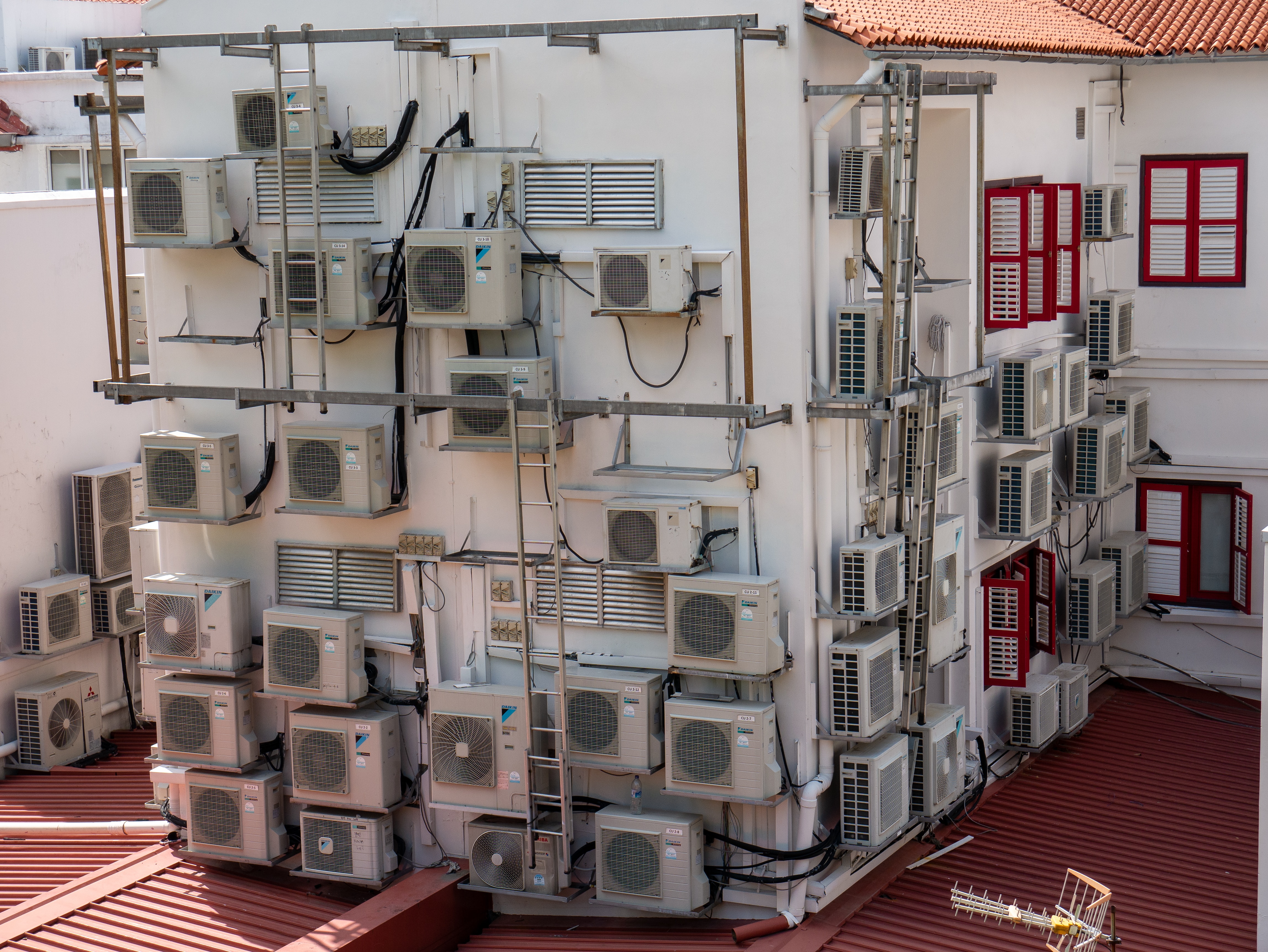 The exterior of a residential building in Singapore covered in mini split air conditioners. Photo: Alexandre Lecocq, 2019.