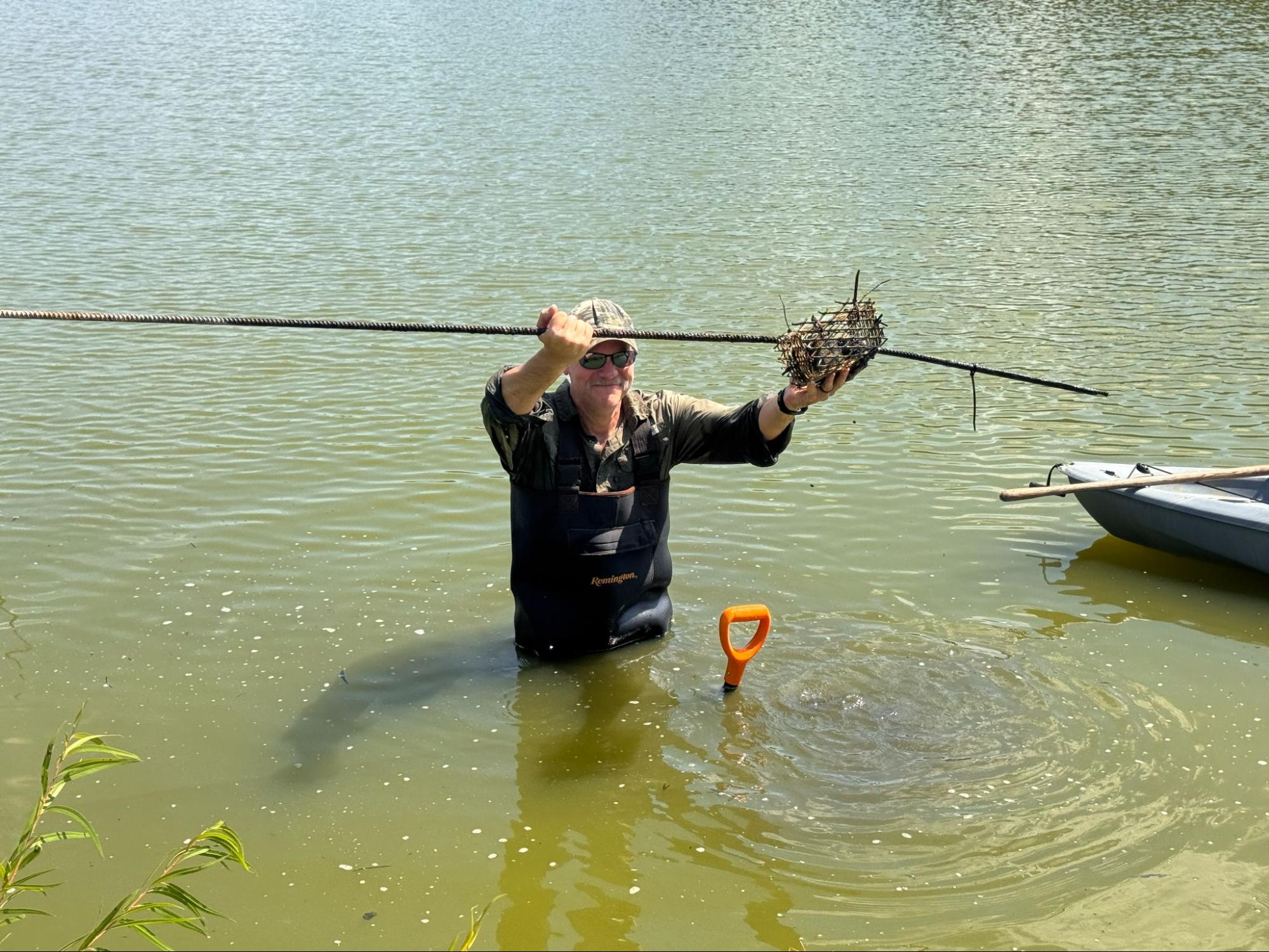 Cade Booth, research associate at Mississippi State University, helping the team to pull wood cookies out of our submerged site. Photo: A. Ting.
